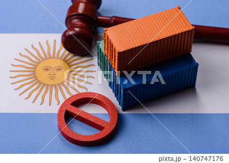 The cargo container ban on the Argentina flag as a conceptual backdrop. The cargo container embargo The cargo container ban on the Argentina flag as a conceptual backdrop. The cargo container embargo 140747176