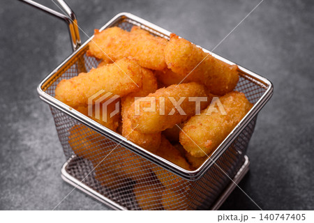 Mozzarella cheese sticks, breaded and fried with salt and tomato sauce, for takeaway. Cheese sticks 140747405