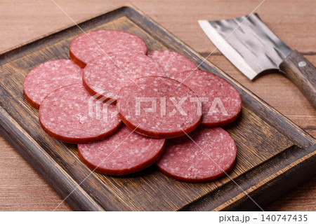 Slices of smoked salami or pepperoni for making sandwiches or pizza at home. Sausage slices 140747435
