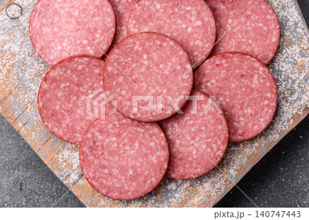 Slices of smoked salami or pepperoni for making sandwiches or pizza at home. Sausage slices Slices of smoked salami or pepperoni for making sandwiches or pizza at home. Sausage slices 140747443