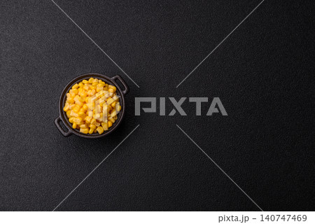 Golden, sweet canned corn kernels or maize for salads and vegetarian dishes. Canned corn 140747469