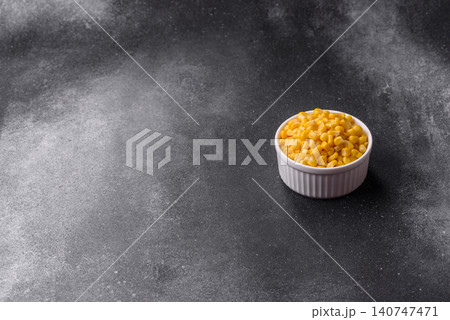 Golden, sweet canned corn kernels or maize for salads and vegetarian dishes. Canned corn 140747471