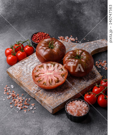 Fresh pink and black tomatoes adora or kumato as an ingredient for a salad. Tomatoes adora or kumato 140747563