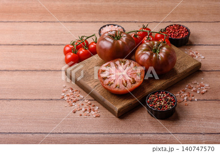 Fresh pink and black tomatoes adora or kumato as an ingredient for a salad. Tomatoes adora or kumato 140747570