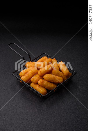 Mozzarella cheese sticks, breaded and fried with salt and tomato sauce, for takeaway. Cheese sticks Mozzarella cheese sticks, breaded and fried with salt and tomato sauce, for takeaway. Cheese sticks 140747587