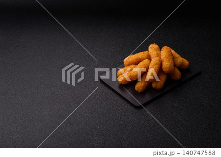Mozzarella cheese sticks, breaded and fried with salt and tomato sauce, for takeaway. Cheese sticks Mozzarella cheese sticks, breaded and fried with salt and tomato sauce, for takeaway. Cheese sticks 140747588