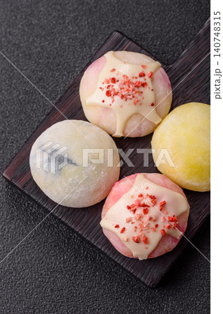 Japanese sweet frozen mochi with rice dough, fruit, and chocolate filling. Japanese mochi Japanese sweet frozen mochi with rice dough, fruit, and chocolate filling. Japanese mochi 140748315