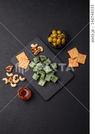 Hard green pesto cheese with herbs as a pasta ingredient. Green pesto cheese 140748333