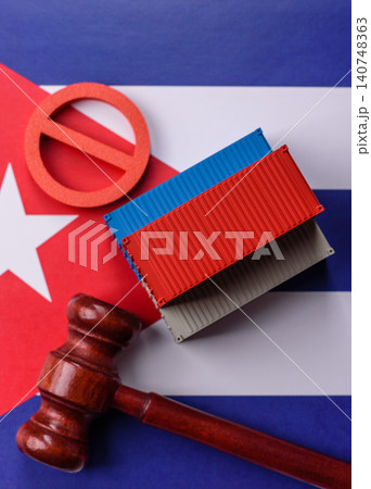 The cargo container ban on the Cuba flag as a conceptual backdrop. The cargo container embargo The cargo container ban on the Cuba flag as a conceptual backdrop. The cargo container embargo 140748363