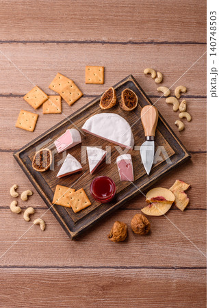 Pink Brie or Camembert cheese with honey, jam, figs, and crackers. Brie cheese Pink Brie or Camembert cheese with honey, jam, figs, and crackers. Brie cheese 140748503