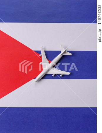 An airplane on the Cuba flag as a conceptual backdrop for travel. An airplane on the Cuban flag An airplane on the Cuba flag as a conceptual backdrop for travel. An airplane on the Cuban flag 140748532