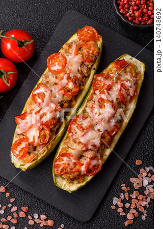 Baked zucchini half with minced meat, tomatoes, cheese, salt, and spices. Zucchini with minced meat Baked zucchini half with minced meat, tomatoes, cheese, salt, and spices. Zucchini with minced meat 140748692