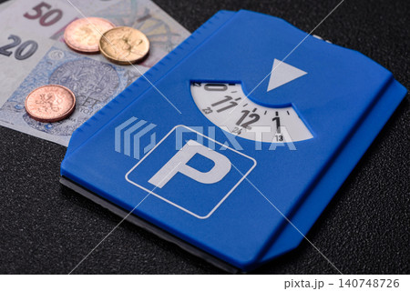 A parking disc, permit, or ticket for measuring time and paying municipal services. A parking disc 140748726