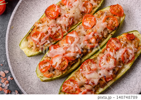 Baked zucchini half with minced meat, tomatoes, cheese, salt, and spices. Zucchini with minced meat 140748789
