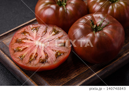 Fresh pink and black tomatoes adora or kumato as an ingredient for a salad. Tomatoes adora or kumato 140748843