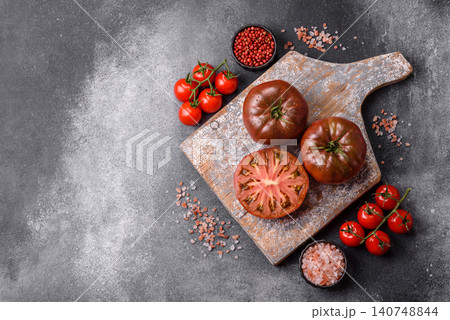 Fresh pink and black tomatoes adora or kumato as an ingredient for a salad. Tomatoes adora or kumato Fresh pink and black tomatoes adora or kumato as an ingredient for a salad. Tomatoes adora or kumato 140748844