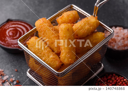 Mozzarella cheese sticks, breaded and fried with salt and tomato sauce, for takeaway. Cheese sticks Mozzarella cheese sticks, breaded and fried with salt and tomato sauce, for takeaway. Cheese sticks 140748868