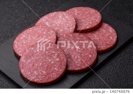 Slices of smoked salami or pepperoni for making sandwiches or pizza at home. Sausage slices 140748876