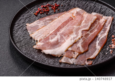 Raw fresh bacon slices with layers of meat or prosciutto with salt and spices. Raw bacon Raw fresh bacon slices with layers of meat or prosciutto with salt and spices. Raw bacon 140748917