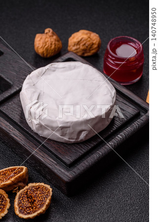 Pink Brie or Camembert cheese with honey, jam, figs, and crackers. Brie cheese Pink Brie or Camembert cheese with honey, jam, figs, and crackers. Brie cheese 140748950