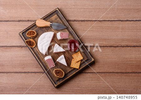 Pink Brie or Camembert cheese with honey, jam, figs, and crackers. Brie cheese Pink Brie or Camembert cheese with honey, jam, figs, and crackers. Brie cheese 140748955
