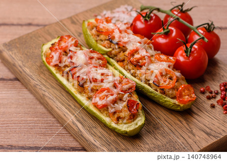Baked zucchini half with minced meat, tomatoes, cheese, salt, and spices. Zucchini with minced meat Baked zucchini half with minced meat, tomatoes, cheese, salt, and spices. Zucchini with minced meat 140748964