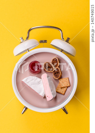 Pink Brie or Camembert cheese with honey, jam, figs, and crackers for a breakfast. Brie cheese Pink Brie or Camembert cheese with honey, jam, figs, and crackers for a breakfast. Brie cheese 140749015