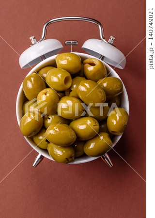 Whole green olives without pits in a bowl as an ingredient for cooking at home. Green olives Whole green olives without pits in a bowl as an ingredient for cooking at home. Green olives 140749021