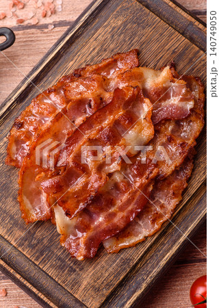 Fried fresh bacon slices with layers of meat or prosciutto with salt and spices. Fried bacon Fried fresh bacon slices with layers of meat or prosciutto with salt and spices. Fried bacon 140749050