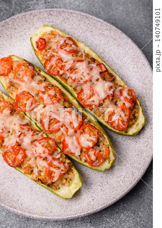 Baked zucchini half with minced meat, tomatoes, cheese, salt, and spices. Zucchini with minced meat Baked zucchini half with minced meat, tomatoes, cheese, salt, and spices. Zucchini with minced meat 140749101