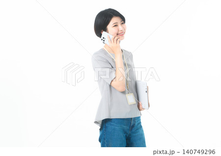 白背景でスマホ通話をしながら微笑む横向きの若い女性 白背景でスマホ通話をしながら微笑む横向きの若い女性 140749296