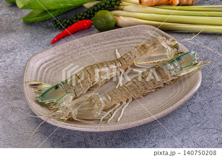 Fresh mantis shrimp on ceramic plate with lime chili and lemongrass background Fresh mantis shrimp on ceramic plate with lime chili and lemongrass background 140750208