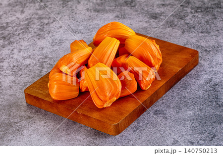 Fresh jackfruit pieces on wooden cutting board Fresh jackfruit pieces on wooden cutting board 140750213