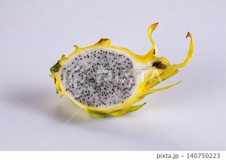 Sliced yellow dragon fruit with white flesh and black seeds on white background Sliced yellow dragon fruit with white flesh and black seeds on white background 140750223