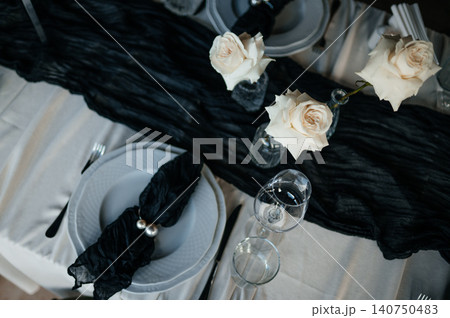 Top view of luxury dark and moody table decor for a fine dining event or reception Top view of luxury dark and moody table decor for a fine dining event or reception 140750483