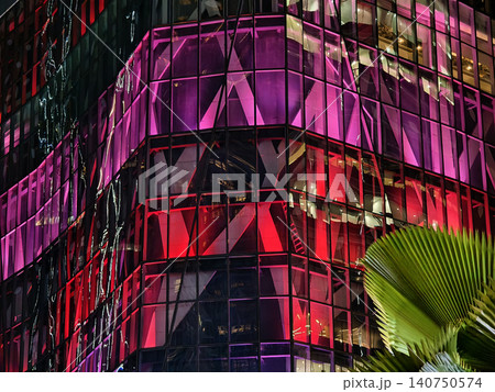 Cityscape illuminated by vivid neon reflections on stylish facades with tropical elements Cityscape illuminated by vivid neon reflections on stylish facades with tropical elements 140750574
