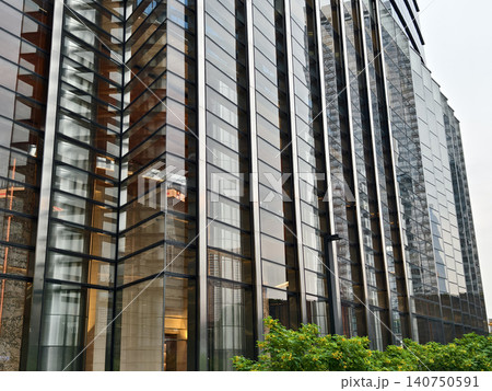 Contemporary glass structure emphasizing sleek reflections and horizontal repetition Contemporary glass structure emphasizing sleek reflections and horizontal repetition 140750591