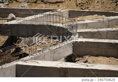 Building process city levee. Exposed foundation rebar grid at site, standing formwork and concrete footings 140750620
