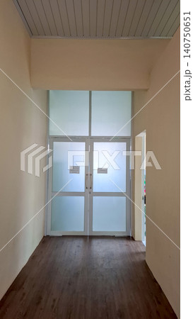 Glass Double Doors in Office Building Hallway 140750651