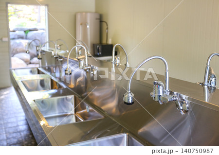 Row of Clean Stainless Steel Sinks and Faucets in a Public Facility Row of Clean Stainless Steel Sinks and Faucets in a Public Facility 140750987