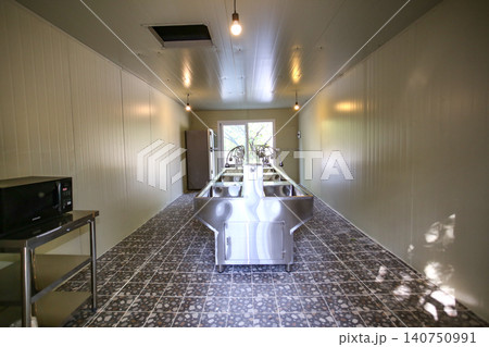 Row of Clean Stainless Steel Sinks and Faucets in a Public Facility 140750991