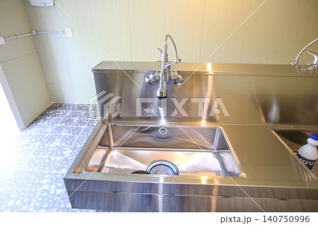 Row of Clean Stainless Steel Sinks and Faucets in a Public Facility Row of Clean Stainless Steel Sinks and Faucets in a Public Facility 140750996