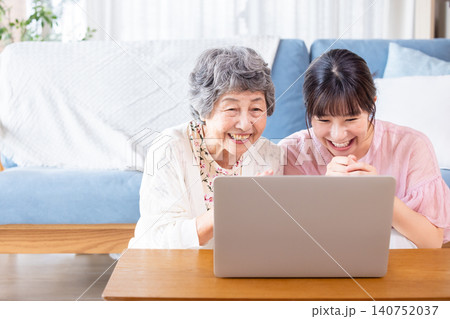 パソコンを見るシニア女性と若い女性 パソコンを見るシニア女性と若い女性 140752037