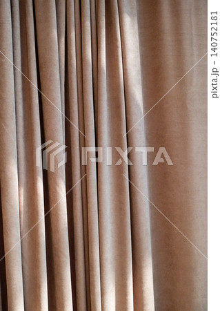 Beige curtains hanging in waves. Fabric texture of window treatment for home interior design. 140752181