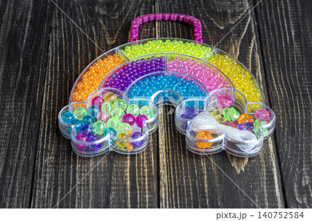 Sets of multi-colored beads and seed beads for children's arts and crafts Sets of multi-colored beads and seed beads for children's arts and crafts 140752584