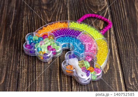 Sets of multi-colored beads and seed beads for children's arts and crafts Sets of multi-colored beads and seed beads for children's arts and crafts 140752585