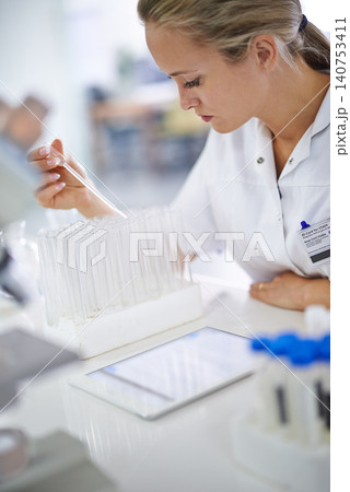 Woman, scientist and vial with test for exam, research or discovery at the laboratory. Female person or medical professional in science experiment with pipette for chemical compound or DNA study Woman, scientist and vial with test for exam, research or discovery at the laboratory. Female person or medical professional in science experiment with pipette for chemical compound or DNA study 140753411