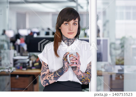 Tattoos, coffee and portrait of business woman in office with positive, good and confident. Grunge, cappuccino and professional edgy creative designer with ink skin standing in modern workplace. 140753523