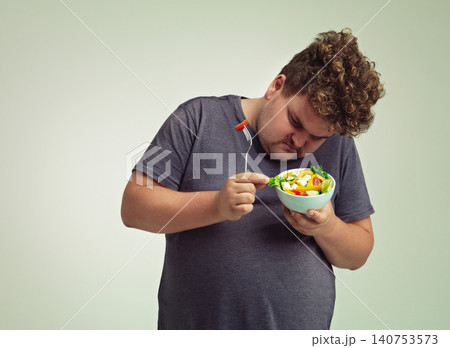 Bowl, man and thinking with salad in studio for healthy diet, weight loss and examine food. Plus size, male person and contemplating with organic meal for detox, lifestyle change and nutrition Bowl, man and thinking with salad in studio for healthy diet, weight loss and examine food. Plus size, male person and contemplating with organic meal for detox, lifestyle change and nutrition 140753573