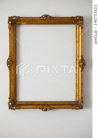 Golden Frame Hanging on a White Wall With No Picture Inside During Daylight Golden Frame Hanging on a White Wall With No Picture Inside During Daylight 140753822